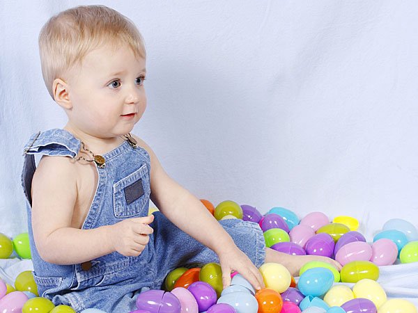 Niño jugando con huevos de Pascua. Tarjeta virtual para los niños