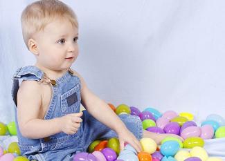 Niño jugando con huevos de Pascua. Tarjeta virtual para los niños